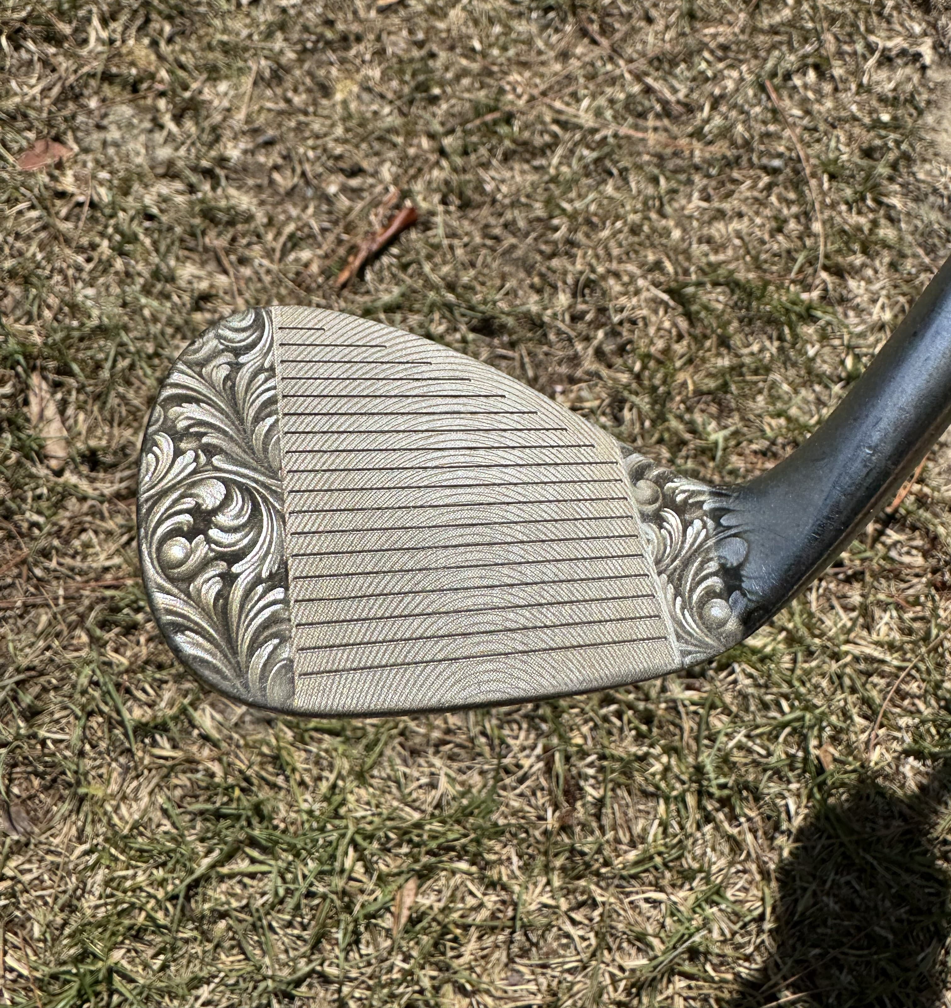 Acanthus pattern engraved across a custom golf wedge