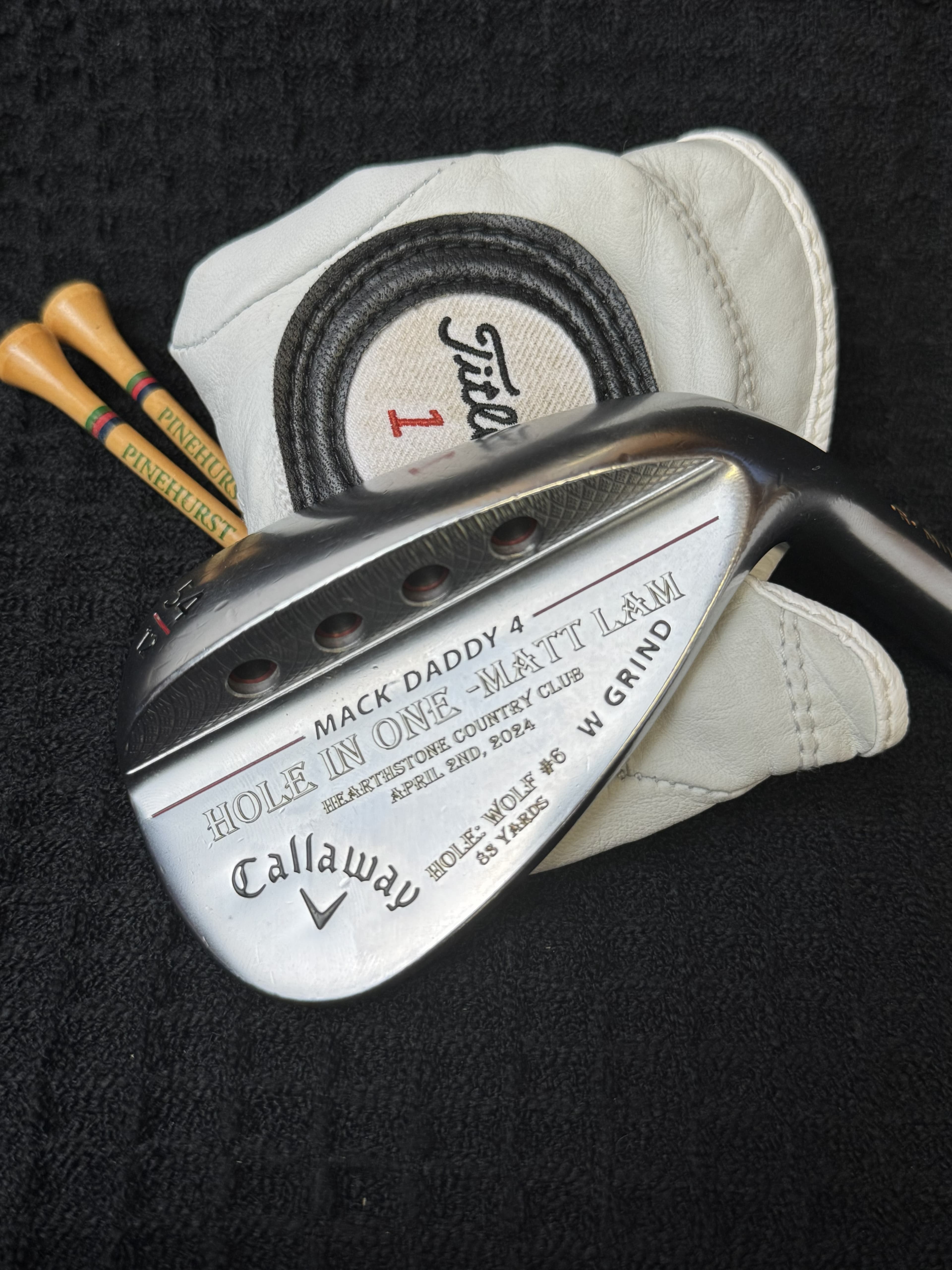 Hole-in-one details engraved on a personalized golf wedge
