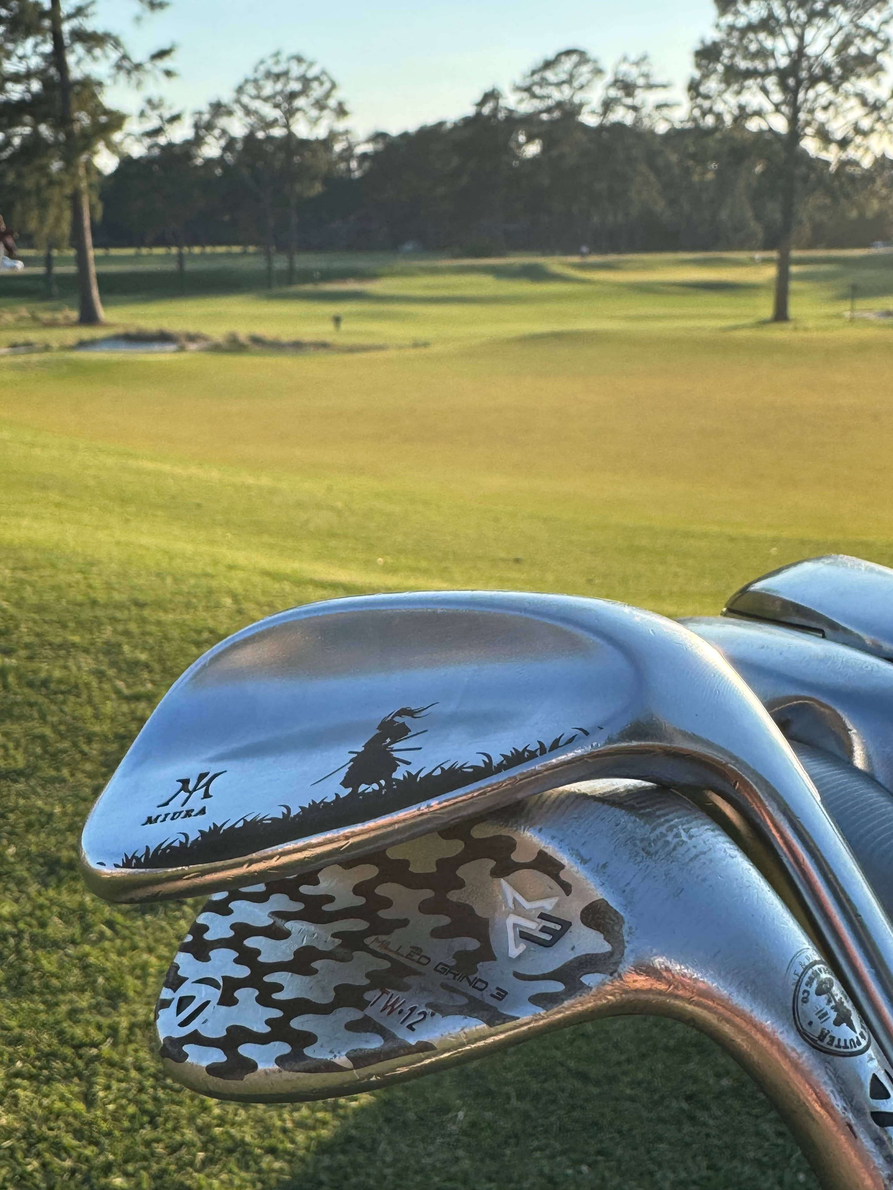 Custom engraved golf clubs photographed on a Pinehurst course